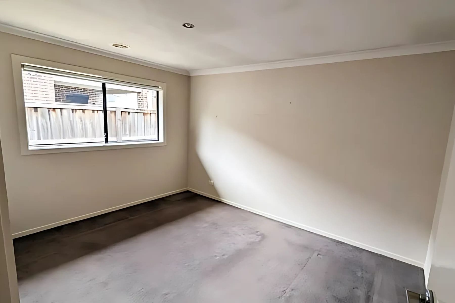 Unfurnished bedroom with natural light and neutral wall colours